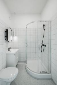 a bathroom with a shower and a toilet and a sink at New York Laisvės al 51A in Kaunas