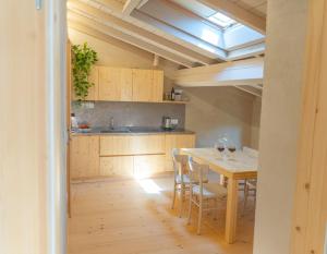 a kitchen with a table and chairs and a dining room at Agriturismo Locanda Case Vecie in Grezzana