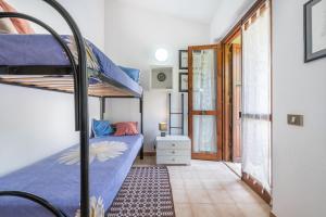 a bedroom with two bunk beds in a room at Villetta Sofia in Costa Rei