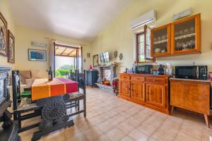 a living room with a couch and a tv at Villetta Sofia in Costa Rei