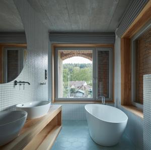 a bathroom with two sinks and a large window at Sýpka Arnoštov 