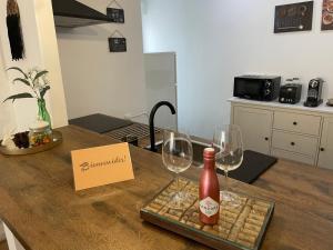 una mesa con dos copas y una botella de vino en Apartamento Marcajada en Riaza