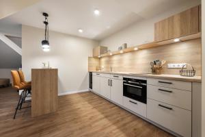 a kitchen with white cabinets and a counter top at My Suite Leesch - Hotel & Restaurant nahe Büsum - Hunde herzlich willkommen in Reinsbüttel