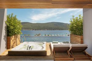 a bath tub on a deck with a view of the water at Titanic Luxury Collection Bodrum in Guvercinlik
