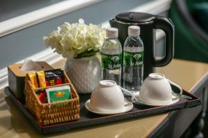 a tray with drinks and snacks on a table at La Selva Premium Hotel in Hanoi