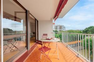 a balcony with a table and a view at Sixties 64 2 bedrooms apartment with a balcony and parking in Biarritz in Biarritz