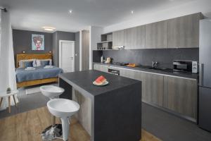 a room with a kitchen and a bedroom with a bed at Studio apartments Villa Valla - free bikes - adults only in Fažana