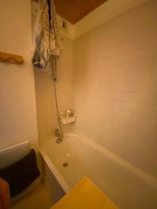 a bathroom with a white tub and a sink at Appartement 4 personnes in Risoul