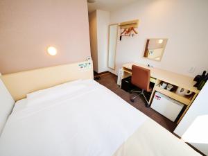 a hotel room with a bed and a desk at Super Hotel Akihabara Suehirocho in Tokyo