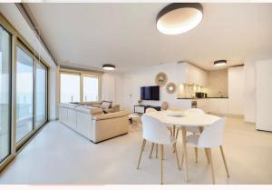 a living room with a table and chairs and a couch at Ostende The Waves in Ostend
