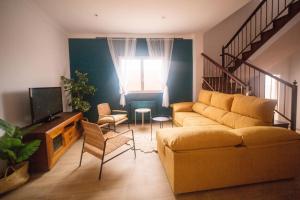 uma sala de estar com um sofá e uma televisão em Villa Oasis em Chío