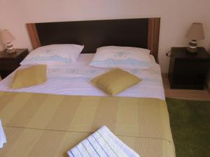 a large white bed with two pillows on it at Apartment Iva in Rovinjsko Selo