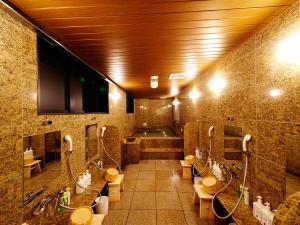 a bathroom with a bunch of sinks and toilets at Super Hotel Akihabara Suehirocho in Tokyo