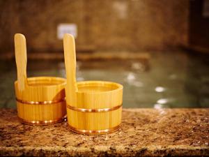 two yellow cups and two wooden spoons on a counter at Super Hotel Akihabara Suehirocho in Tokyo