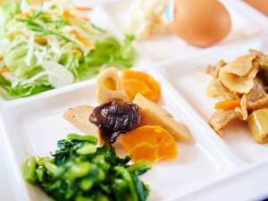 a plate of food with broccoli and vegetables on it at Super Hotel Akihabara Suehirocho in Tokyo
