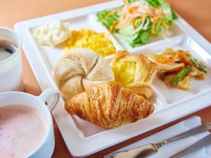 a plate of food with pastries and a bowl of soup at Super Hotel Akihabara Suehirocho in Tokyo