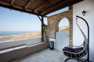 a room with a balcony with a view of the ocean at Luxury Suite in Dyo Choria in Tinos