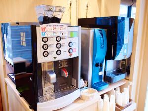a coffee maker sitting on a shelf in a kitchen at Super Hotel Akihabara Suehirocho in Tokyo