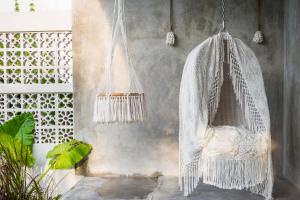 a white hammock hanging from a wall at ROMANTIC GETAWAY - ARCHITECTURAL MASTERPIECE 1BR in Canggu