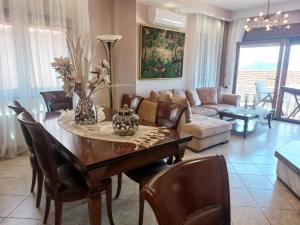 a living room with a table and a couch at Saguaro’s home Kavala in Kavála