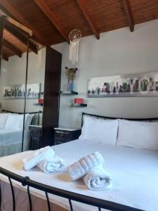 a bedroom with two towels on a bed at Saguaro’s home Kavala in Kavála