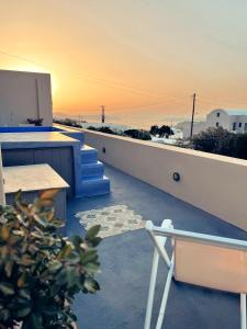 a balcony with a view of the ocean at sunset at Flora's House & Cave Winery in Pirgos