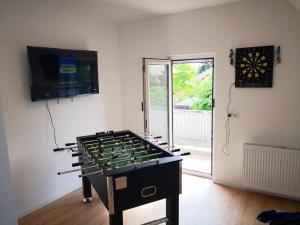 a large game room with a large foosball table at Boardinghouse in Mörfelden-Walldorf in Mörfelden-Walldorf