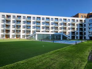 a large building with a lawn in front of it at Apartament Bel Mare F 604 in Międzyzdroje