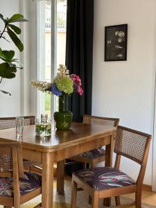 a dining room table with a vase of flowers on it at Apartment Luk in Furth im Wald