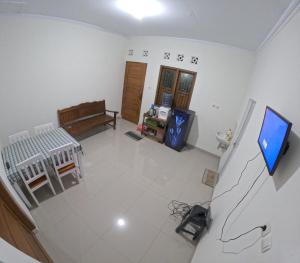 an overhead view of a living room with a flat screen tv at Bovalia Homestay Jogja in Seturan
