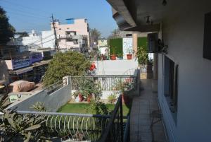 a balcony of a house with plants on it at Blue Beds Homestay, Exotic 2BHK AC House in Jabalpur