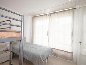 a bedroom with a bunk bed and a window at Casa Angel in L'Escala