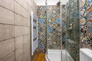 a bathroom with mosaic tiles on the walls and a shower at Sizgoric Palace Suites Sibenik in Šibenik