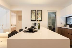 a kitchen with a large white island in a room at Stunning Modern 1BD Apartment in Barranco in Lima