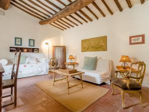 a living room with a couch and a table at Cosy Farmhouse in Bacchereto with Swimming Pool in Carmignano