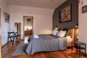 a bedroom with a bed and a wooden floor at Spacious 2-story apt. w/ terrace - 280 m2 in Riga +34 photos