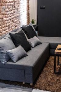 a couch with pillows on it in a living room at Krakowskie30 Loft1 deptak in Lublin