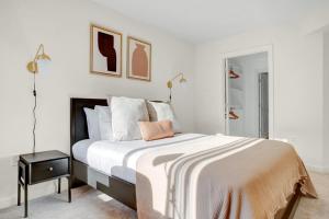 a white bedroom with a large bed and a table at Bethesda 1BR w Concierge Gym WD nr Metro WDC-333 in Bethesda +36 photos