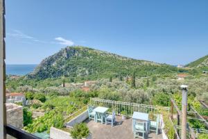 a view from the balcony of a house with a mountain at Eva's country house in Buljarica