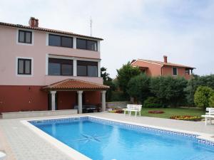 a swimming pool in front of a house at Charming Apartment in Banjole near Sea in Banjole