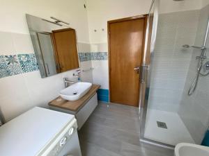 a bathroom with a shower and a sink and a toilet at Casa Vacanze Montes per 9 con 3 bagni vicino Cala Gonone in Dorgali +28 photos