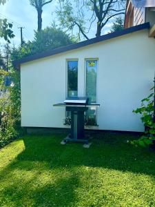 a laptop sitting on a table in front of a house at Domek dla dwojga in Tylicz +4 photos