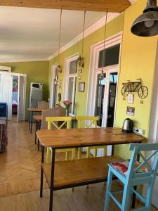 a dining room with a table and a bike on the wall at Hostel ERA in Tbilisi City