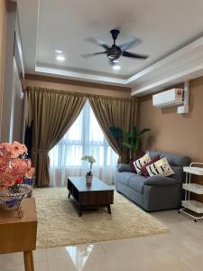 a living room with a couch and a ceiling fan at M Centura Sentul in Kuala Lumpur