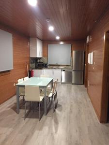 a kitchen with a table and chairs in a room at Quinta do Farejal in Vieira do Minho