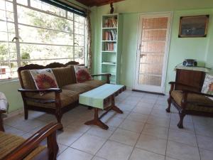 a living room with a couch and a coffee table at Dinizulu Cottage in Hluhluwe