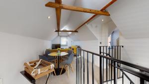a room with a staircase with a table and chairs at Beautiful Coach House in Gloucester
