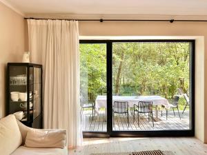 a living room with a sliding glass door to a patio at Gniazdowo nad rzeką - dom z sauną i masażem in Łochów