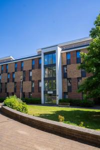 a large brick building with a large window at Cosy Studios at New Hall located in the heart of Nottingham in Nottingham