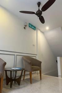 a waiting room with a ceiling fan and a table at M S Hotel, Tengku Kelana KTM Klang in Klang